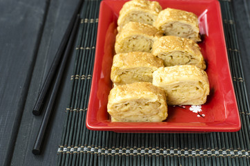 Japanese omelet tamago-yaki with black sesame seeds  