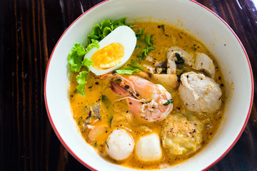 Asian noodle with seafood and egg in the tomyum soup