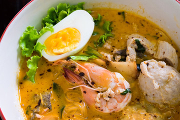 Asian noodle with seafood and egg in the tomyum soup