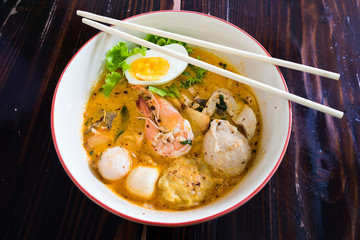 Asian noodle with seafood and egg in the tomyum soup