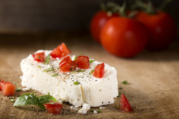Cheese with green basil leaves