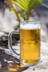 Glasses of beer on beach
