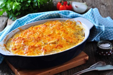 potato casserole with chicken, onions and cheese