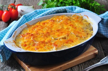 potato casserole with chicken, onions and cheese