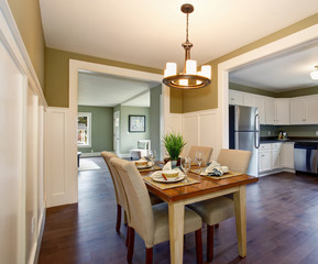 Modern dinning room with hardwood floor and hanging light fixtur