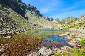 Naklejka na ściany i meble View of alpine lake in summer landscape of Starolesna valley, High Tatra Mountains, Slovakia