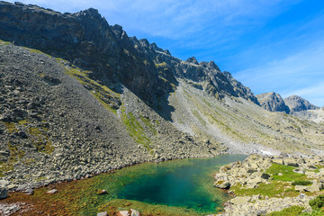 View of alpine lake in summer landscape of Starolesna valley, High Tatra Mountains, Slovakia