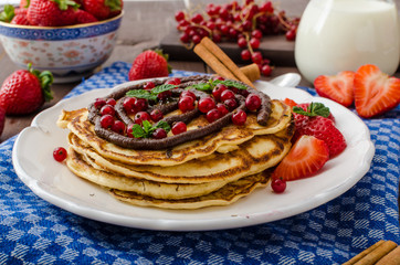Cinnamon pancakes with chocolate sauce and berries