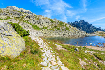 Hiking path along beautiful lake in Starolesna valley in summer time, High Tatra Mountains, Slovakia