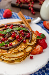 Cinnamon pancakes with chocolate sauce and berries