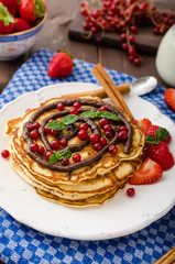 Cinnamon pancakes with chocolate sauce and berries