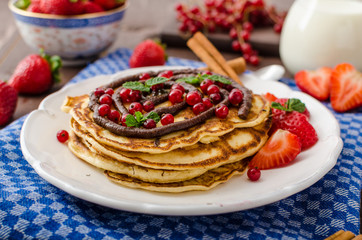 Cinnamon pancakes with chocolate sauce and berries