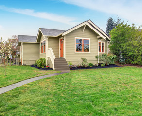 Fototapeta na wymiar Lovely American home with grass filled lawn.