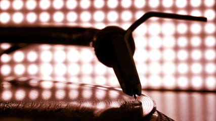 Dj needle stylus on record, blur light background