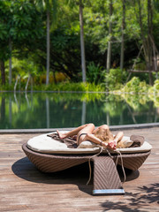 Obraz premium girl resting by the swimming pool