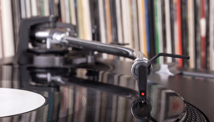 Dj stylus on spinning vinyl, record background