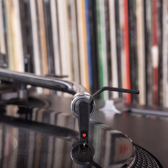 Dj stylus on spinning vinyl, record background
