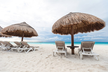 Sun umbrellas and chairs on caribbean beach