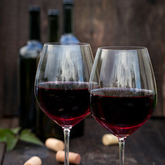 Glass of red wine on old wooden table