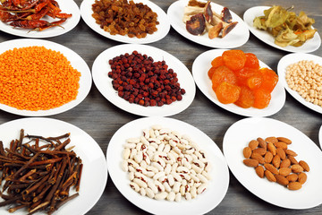 Different products on saucers on wooden table, closeup