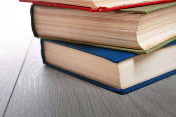 Stack of books on wooden background