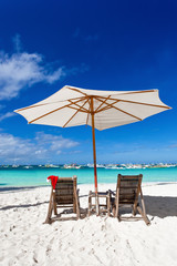 Sun umbrella with Santa Claus Hat on chairs