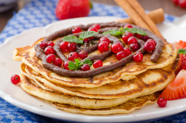 Cinnamon pancakes with chocolate sauce and berries