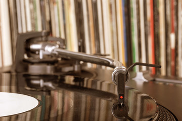 Dj stylus on spinning vinyl, record background