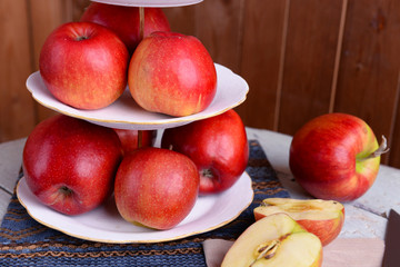 Naklejka na ściany i meble Tasty ripe apples on serving tray on table close up