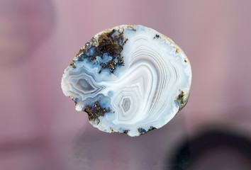 Blue and white agate on a pink background