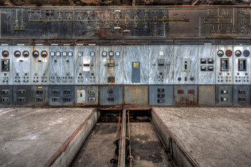 Wall of power control panels in an abandoned power plant