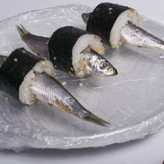 Fresh raw European sprats modern sushi on plate in plastic