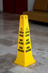 Yellow sign caution wet floor