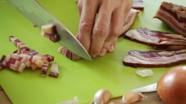 HD 1080 close up: chef chopping pancetta bacon onto small chunks using sharp knife