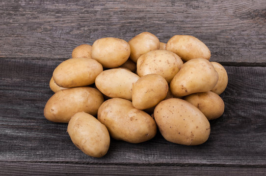 Young   potatoes on wooden table close up