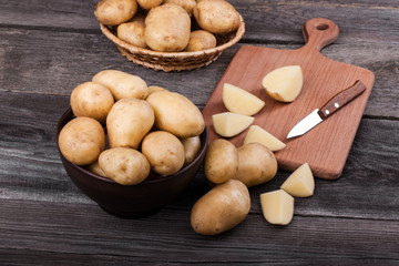Young sliced  potatoes on wooden table close up
