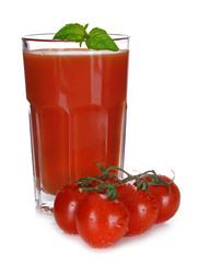 Glass of tomato juice with green leaves isolated on white