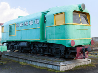 Fototapeta na wymiar Green narrow gauge locomotive. The oldest narrow-gauge railway depot in Russia