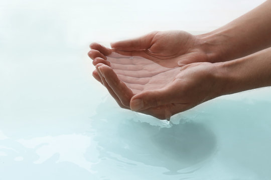 Female hands over clear water background