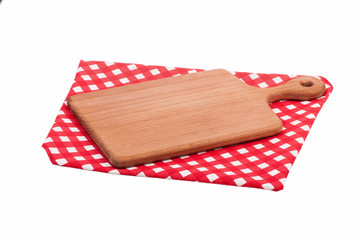 Cutting board isolated on red checkered tablecloth