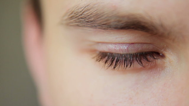 Attractive Young Man Looks Into The Camera and closes his eyes close up