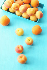 Ripe apricots on metal tray on table close up