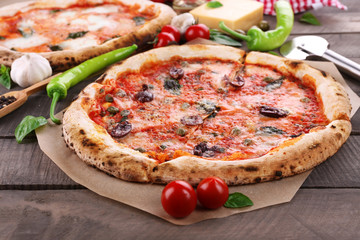 Delicious pizzas on wooden table, closeup