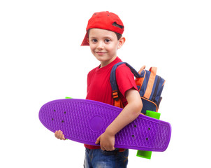 Smiling schoolkid standing with skateboard and backpack on white © cristovao31
