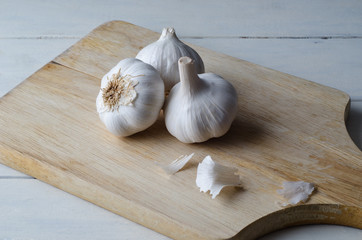 Garlic Bulbs on Chopping Board - Angled Elevated View