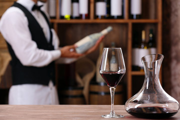 Bartender working at counter on bar background