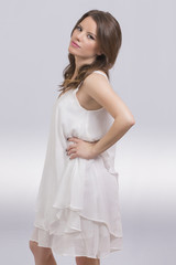 Fototapeta na wymiar Beautiful girl in a white dress