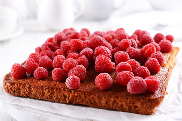 Fresh pie with raspberry on wooden tray, closeup