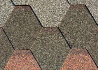 Different color shingles or bitumen tile background. Abrasive texture roofing material.
