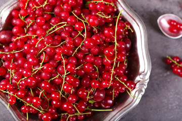 Ripe red currants in metal bowl on table, top view